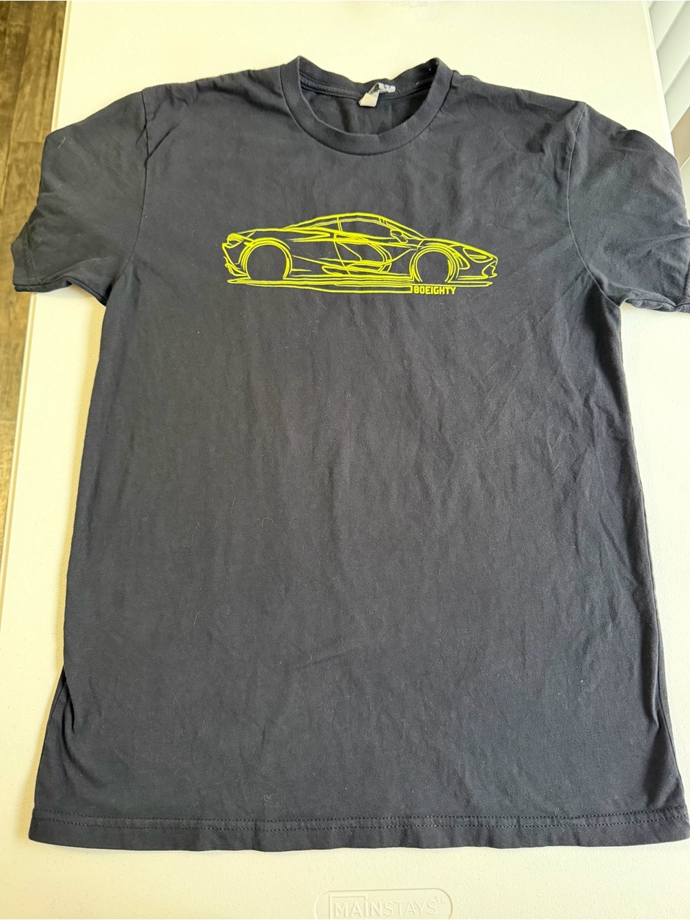 Men’s Next Level black t-shirt with yellow race car graphic size small T0116